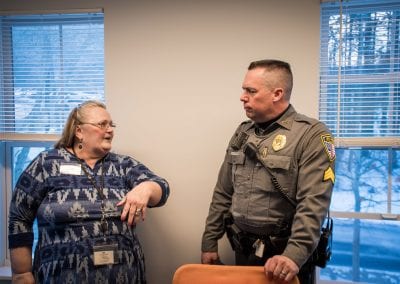 An UCS counselor chats with an officer of the Bennington Police Department at the PUCK Open House, January 2020