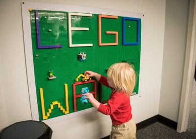 A young guest interacts with the Lego wall, one of PUCK's many therapeutic items, at the open house in January 2020.